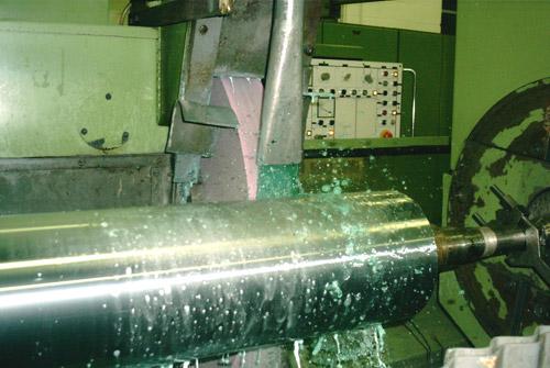 A roll face being finish ground after hard chrome plating.