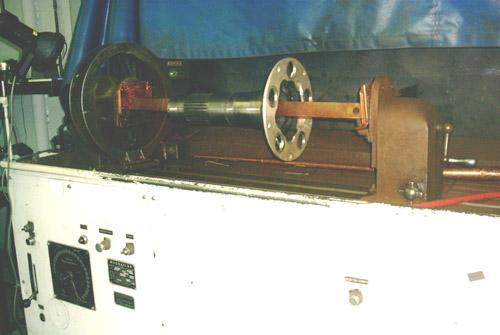 A flanged prop shaft mounted in the magnetic particle inspection unit.