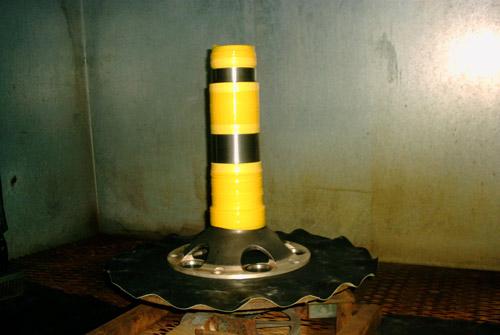 A prop shaft masked in yellow tape ready for shot peening.