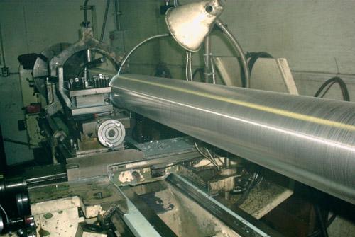 Shaft material being rough machined on a lathe.