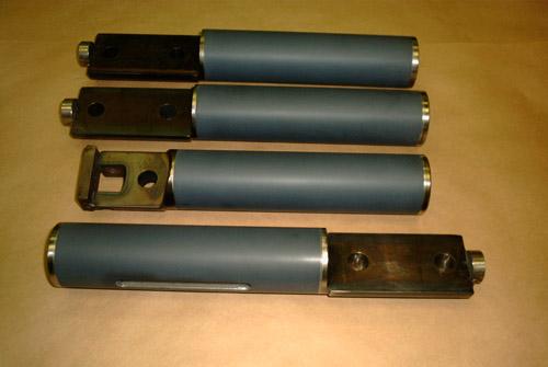 Four ram shafts with plasma sprayed ceramic sections, finish ground.