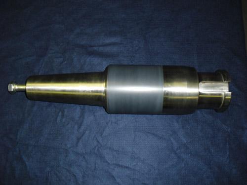A taper shaft with a plasma sprayed ceramic band, finish ground.
